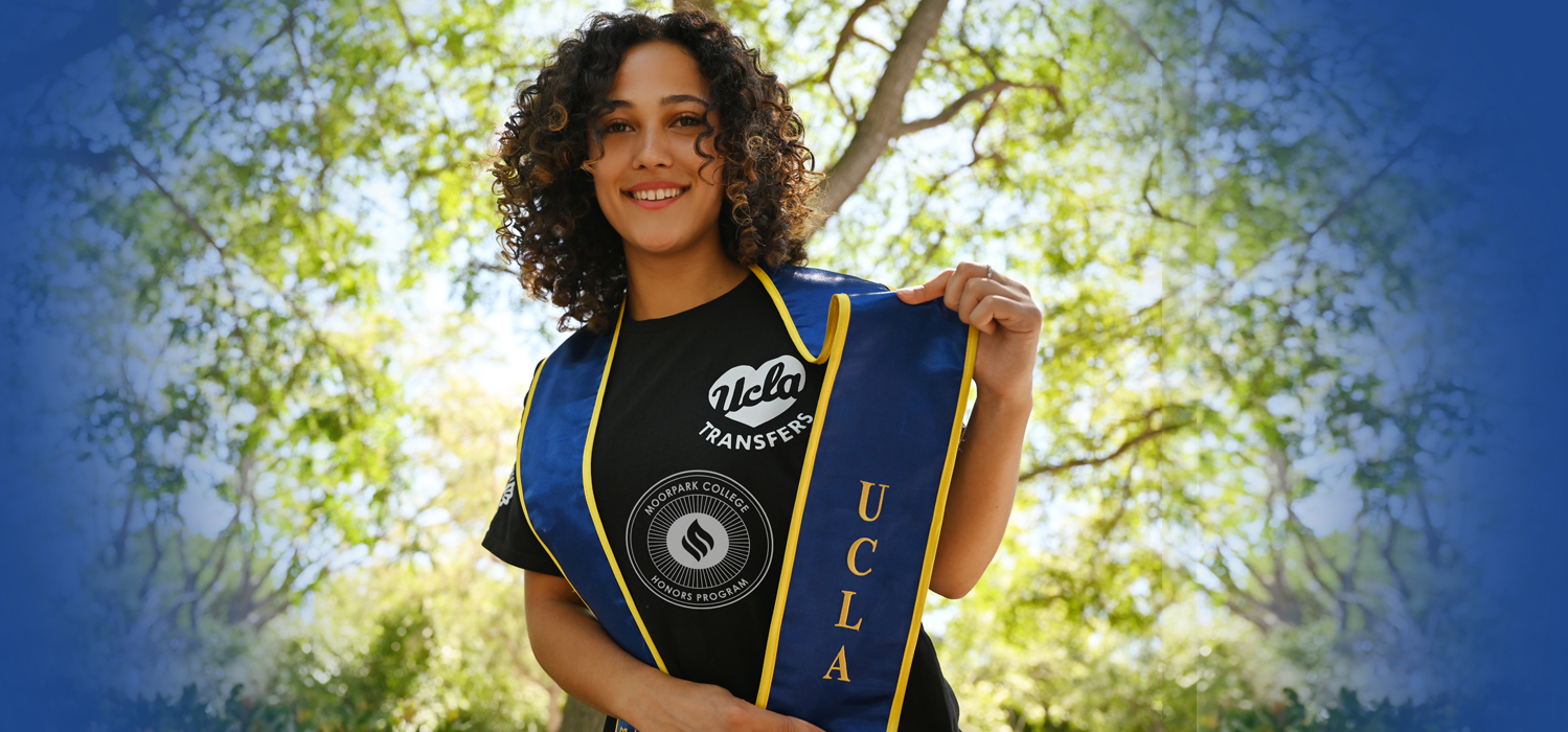 smilimg lady showing off UCLA garb